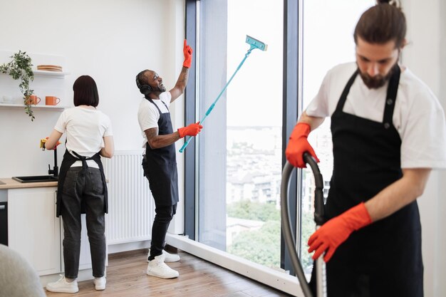 Professional cleaner washing large panoramic windows during a deep house cleaning session in London