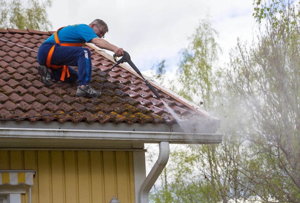 Washing Roof's Gutter by professional cleaner